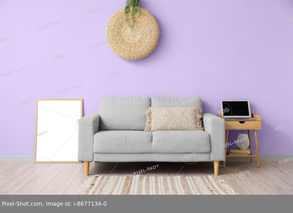 Удобный диван, пустая фоторамка и стол с современным ноутбуком возле  цветной стены в интерьере комнаты :: Стоковая фотография :: Pixel-Shot  Studio